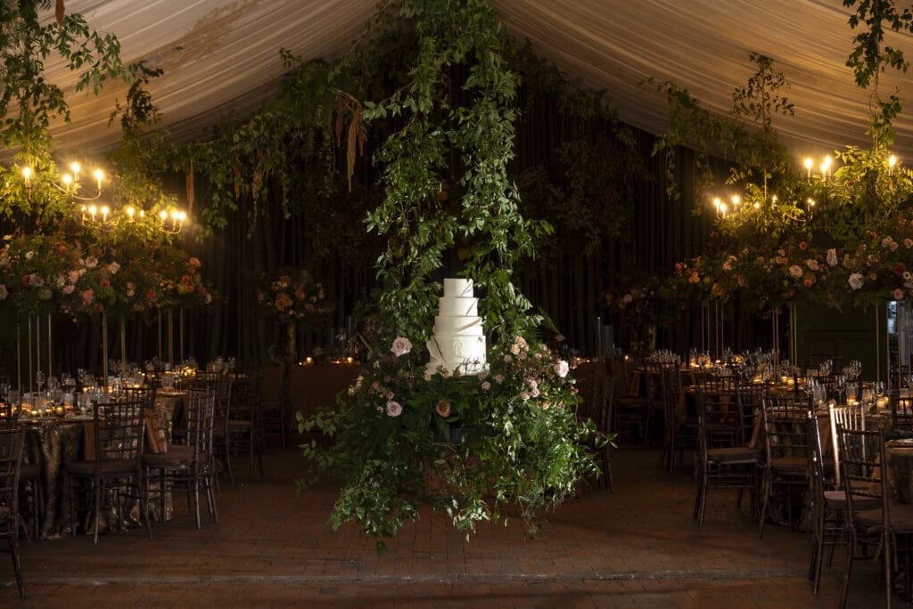 wide view of floating wedding cake surrounded by reception decor