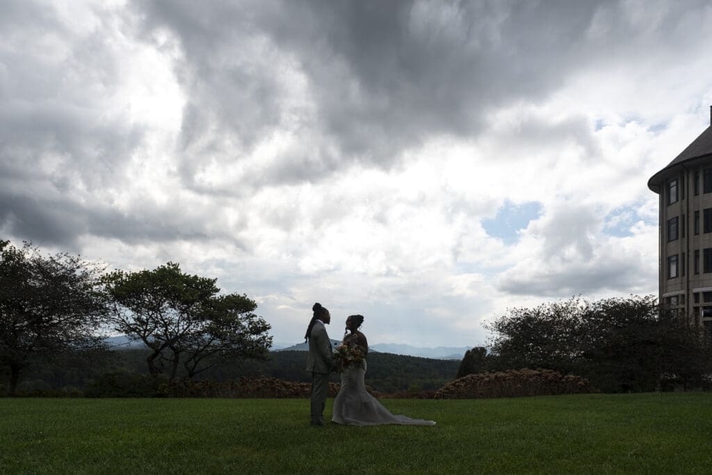 Landscape silhouette with bide and groom holding hands in the center at the Inn at biltmore estate