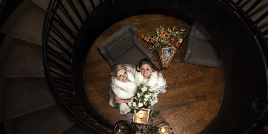 Picture of brides at bottom of stairs