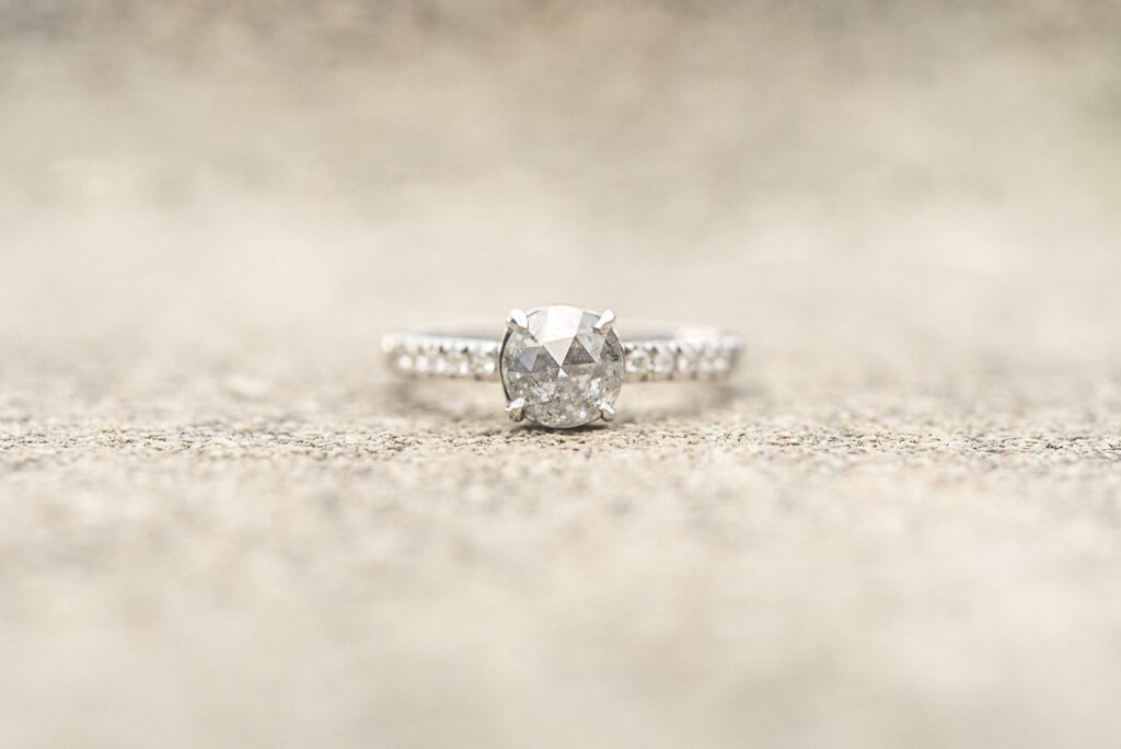 close up of salt and pepper diamond engagement ring with while gold band