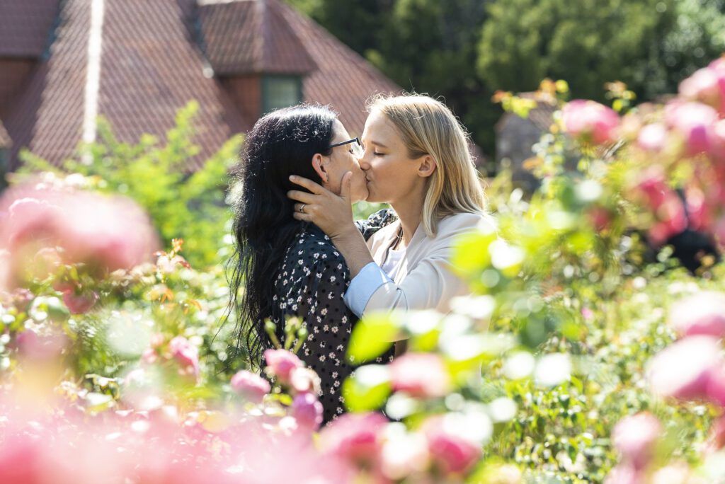 lesbian couple kissing in Biltmore rose garden