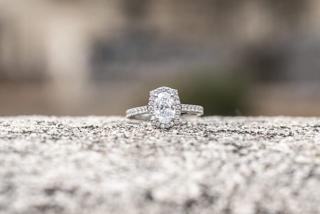 oval diamond engagement ring with diamond band and diamond halo set in a white gold band