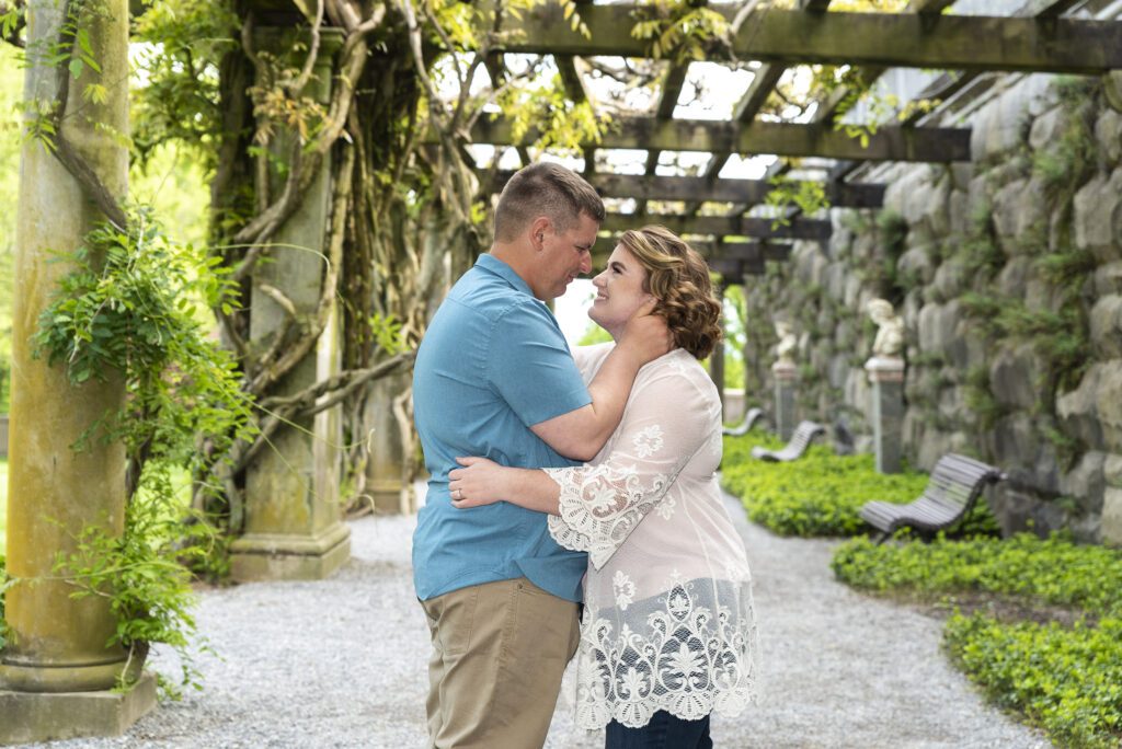 couple standing under wisteria at biltmore estate