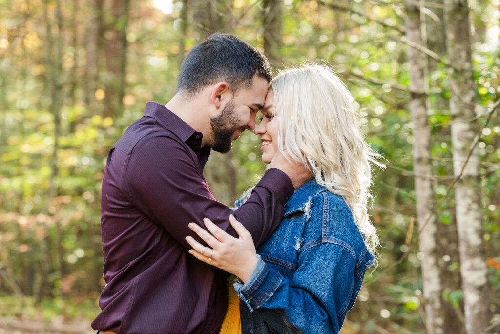 man smiling and holding woman's face to his.