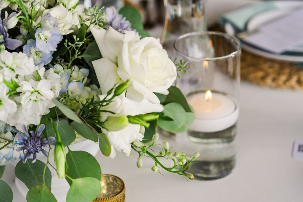 close up of reception table flowers and candle