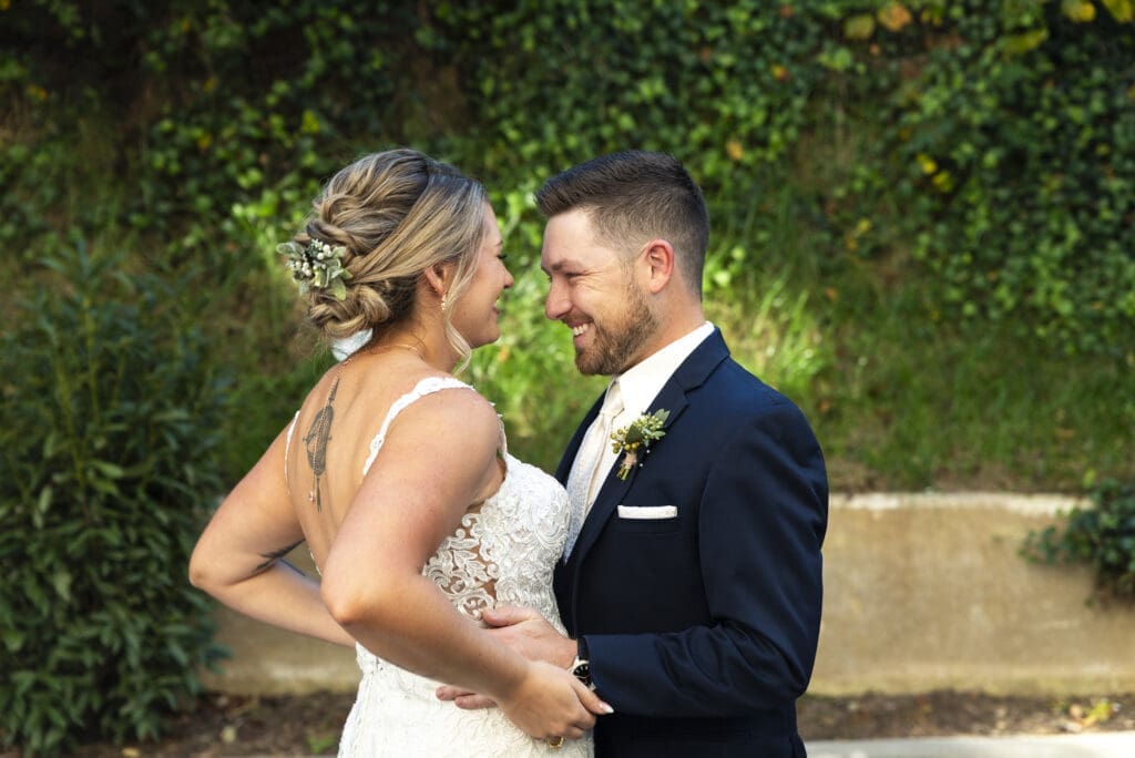 bride and groom holding hands during first look in asheville for crest center wedding