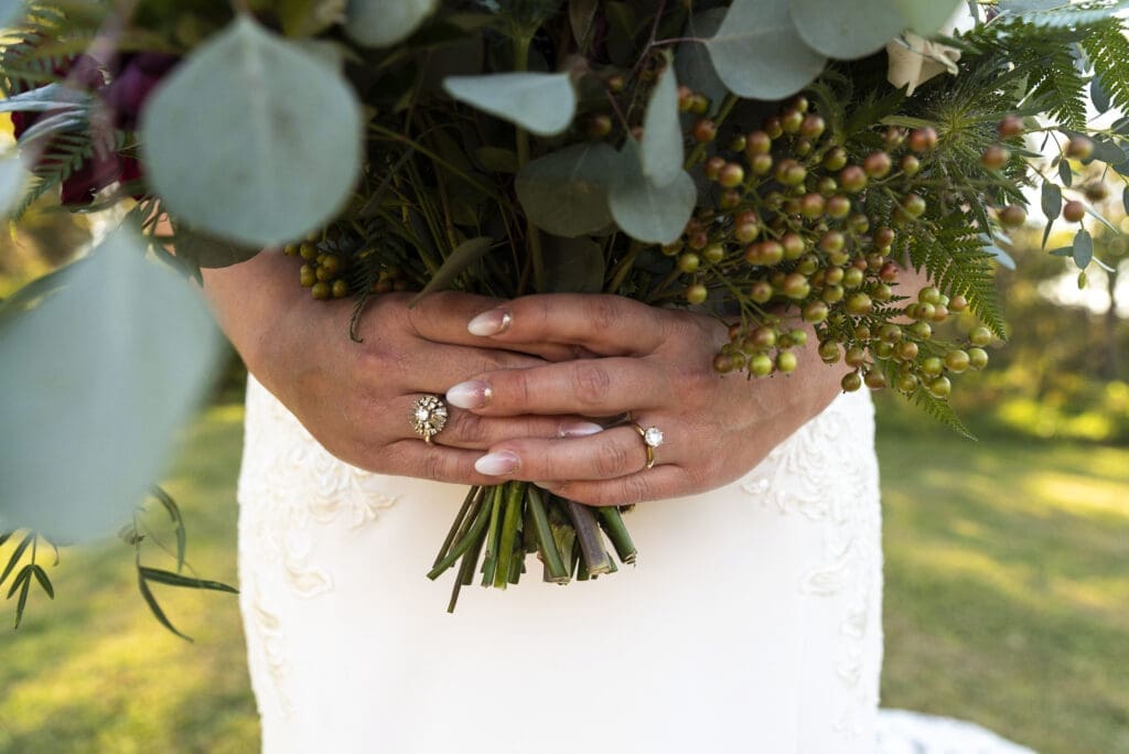 close up of bride's hands holding bouquet