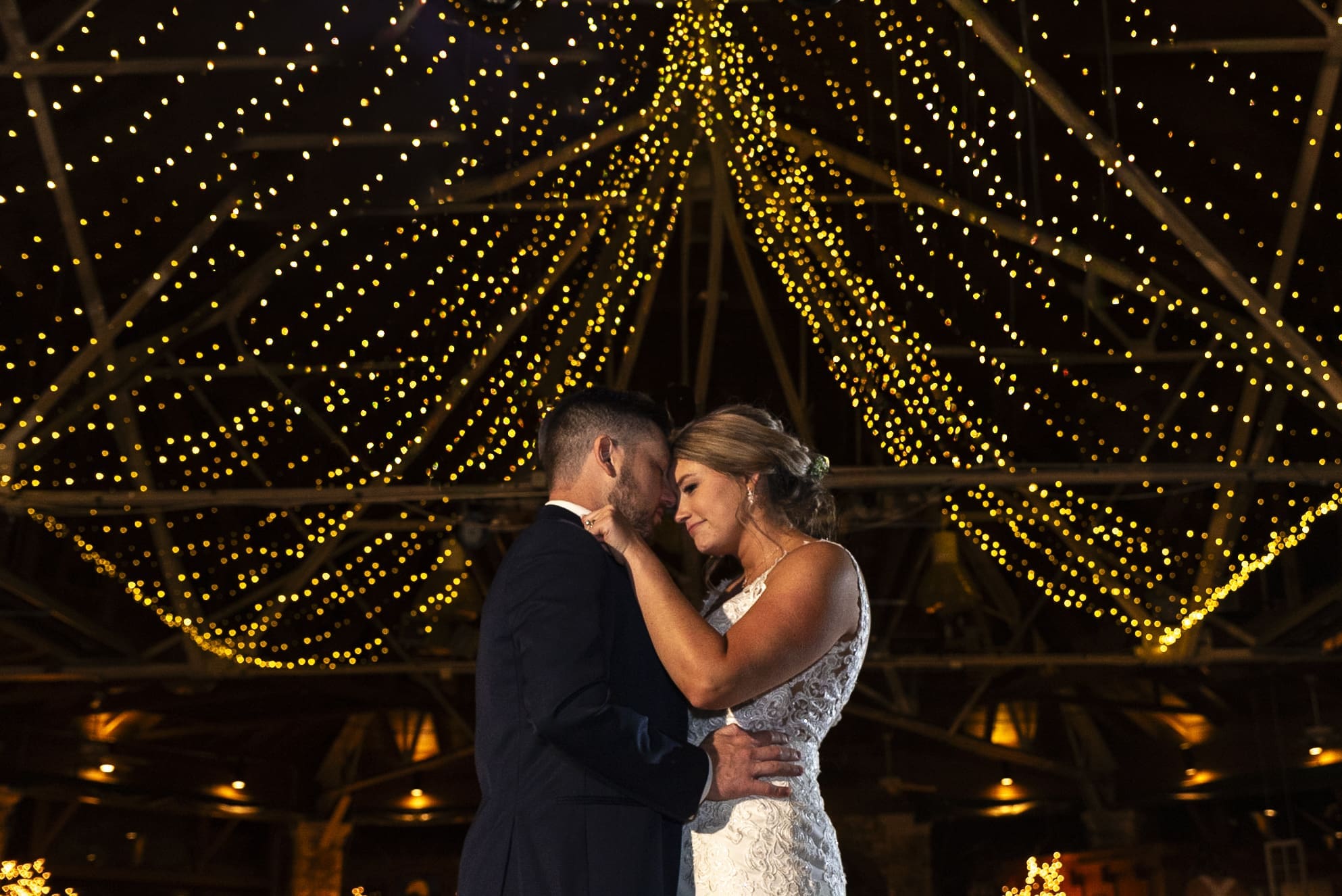 bride and groom slow dancing forehead to forhead during their first dance at Crest Center in Asheville.