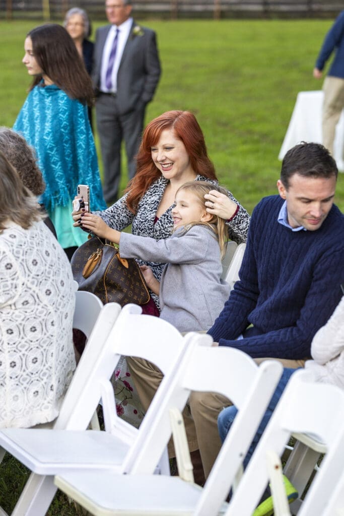 wedding guest smiling before ceremony