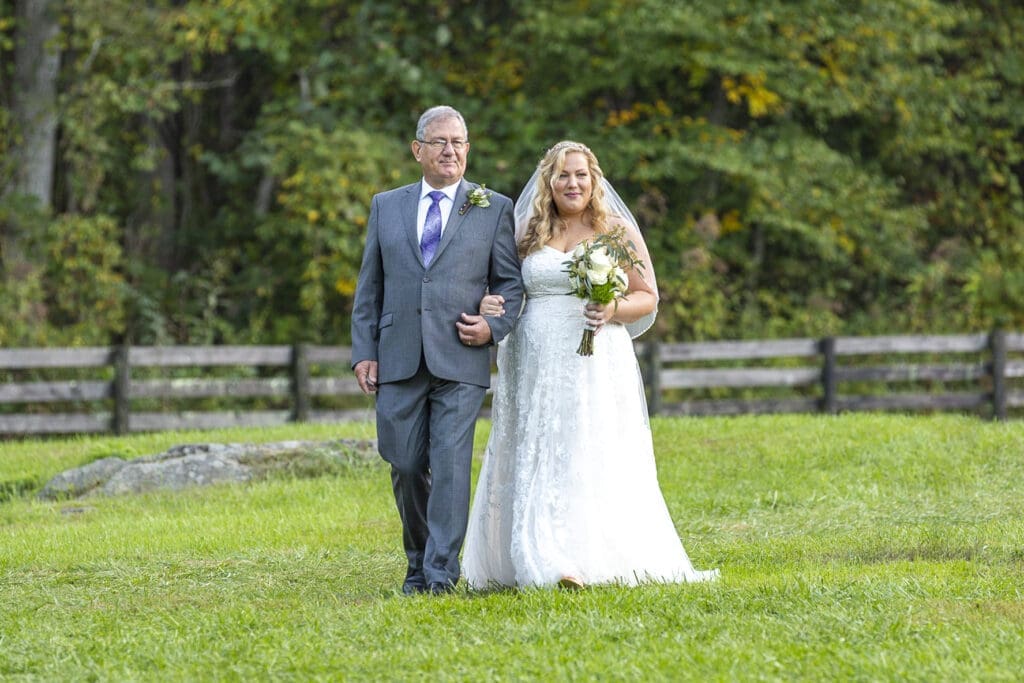 bride and father walking down aisle during ceremony
