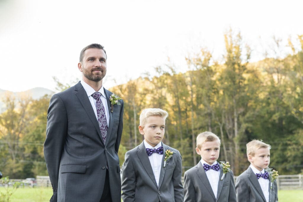 Groom and his groomsman sons waiting for bride