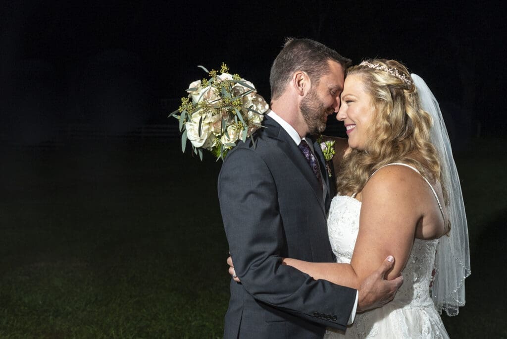 Bride and groom embracing after sunset