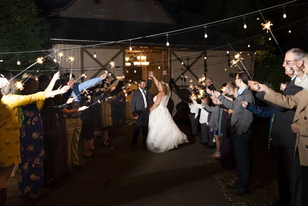 groom twirling bride through sparkler exit leaving Fields of Blackberry cove