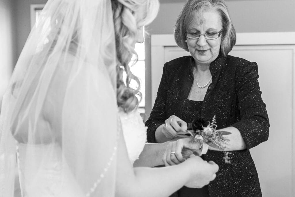 bride's mother helping her put on jewelry