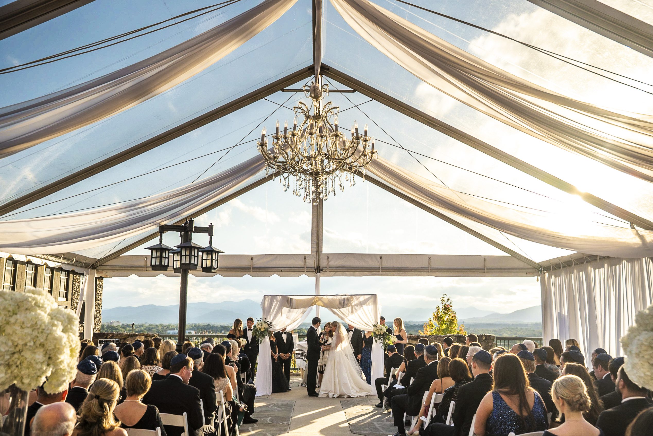 bride and groom holding hands and saying vows during the ceremony at grove park Mountain View Terrace & Skyline Room