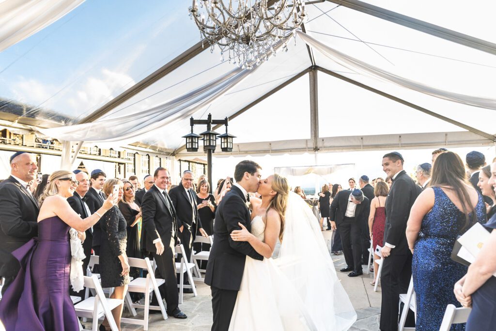 bride and groom kiss at end of ceremony aisle during recession at Grove park Mountain View Terrace & Skyline Room