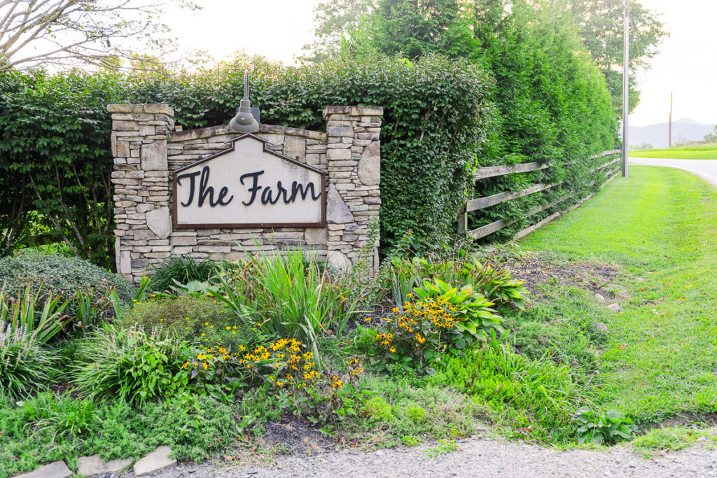 entrance sign for The Farm A Gathering Place Asheville Candler Wedding Venue