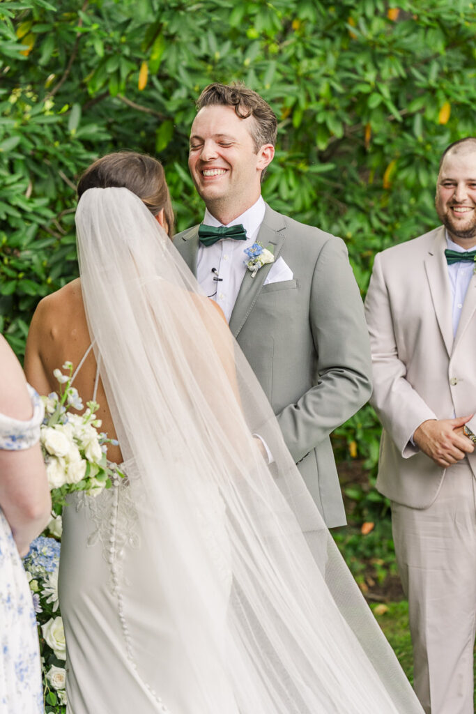 groom smiling at bride during ceremony vows