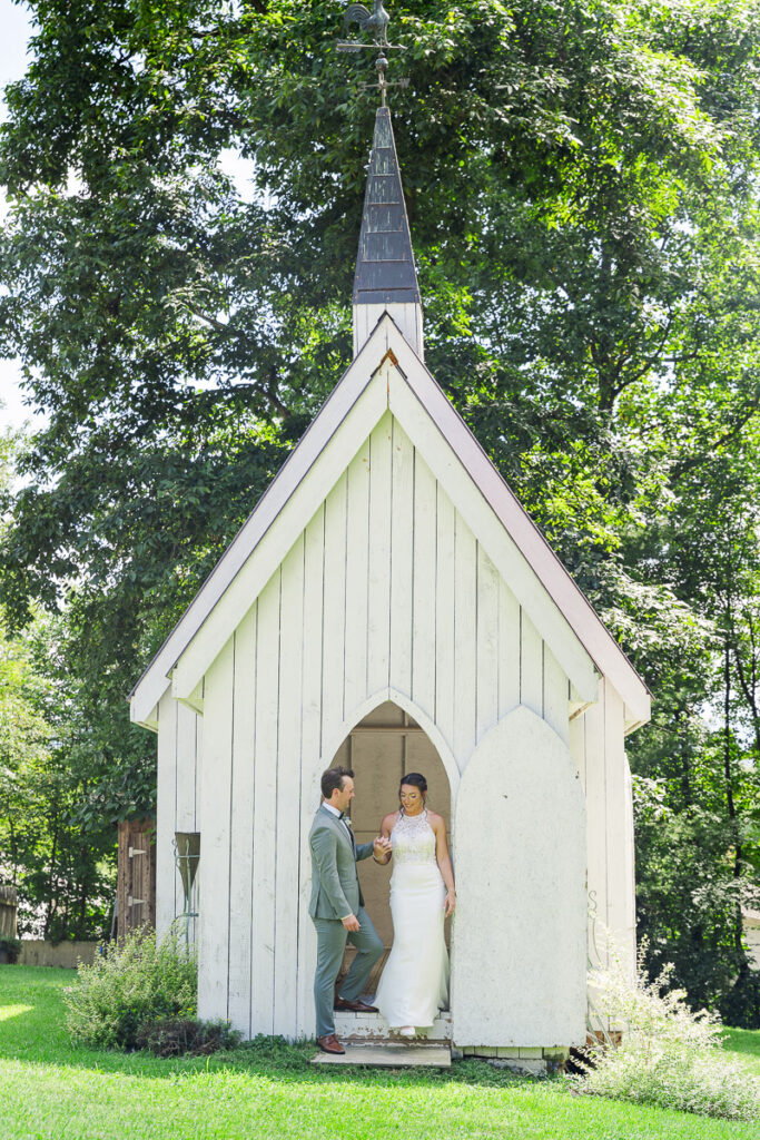 groom helping bride out of the chicken chapel at The Farm A Gathering Place