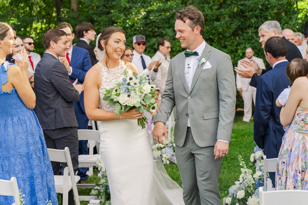 recessional couple smiling at each other