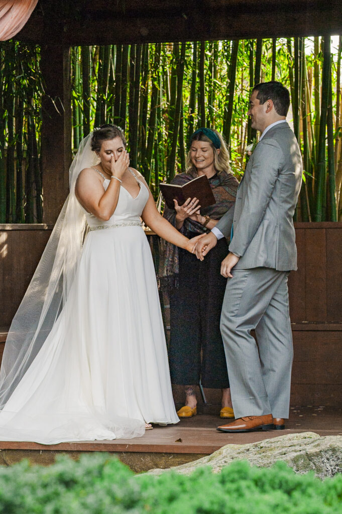 bride wiping her face during the ceremony at Weaver House wedding venue