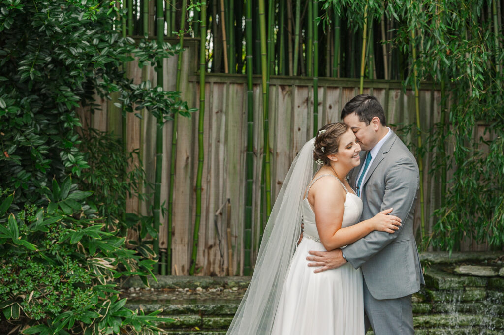 wide portrait of bride and groom embracing and smiling at each other at Weaver House wedding venue