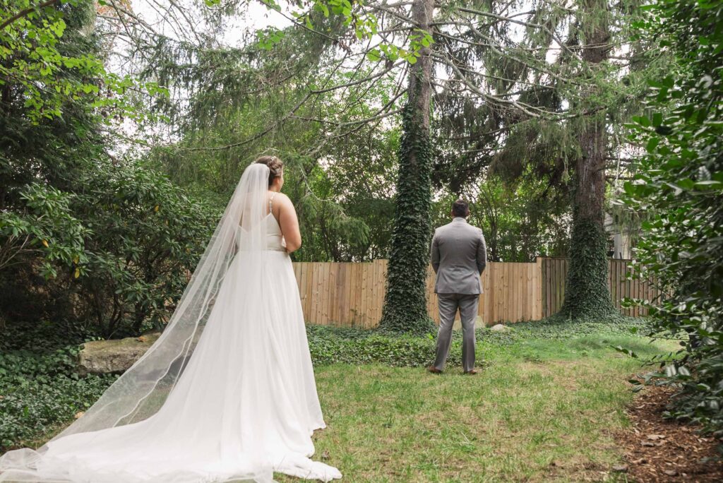 bride and groom standing in place for first look at Weaver House wedding venue
