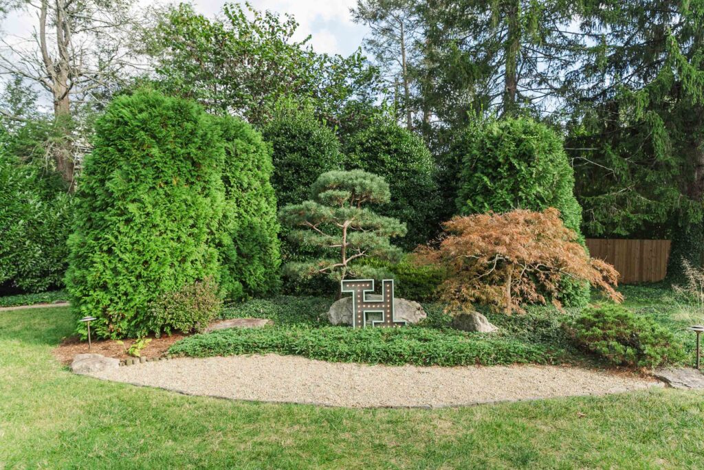 landscape at Weaver House wedding venue with a handmade sign of bride and groom's initials