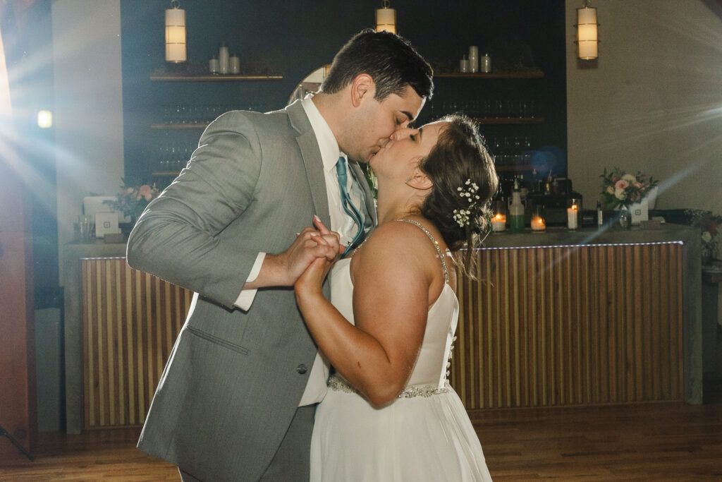 bride and groom kissing during their last dance