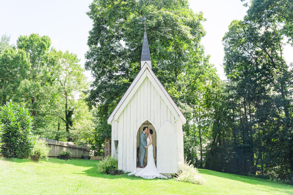 groom kissing bride in chicken chapel at The Farm A Gathering Place