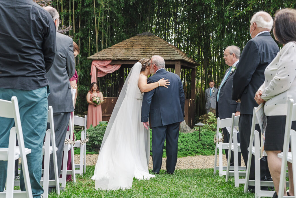 father of the Bride kissing bride as he gives her away at Weaver House wedding venue