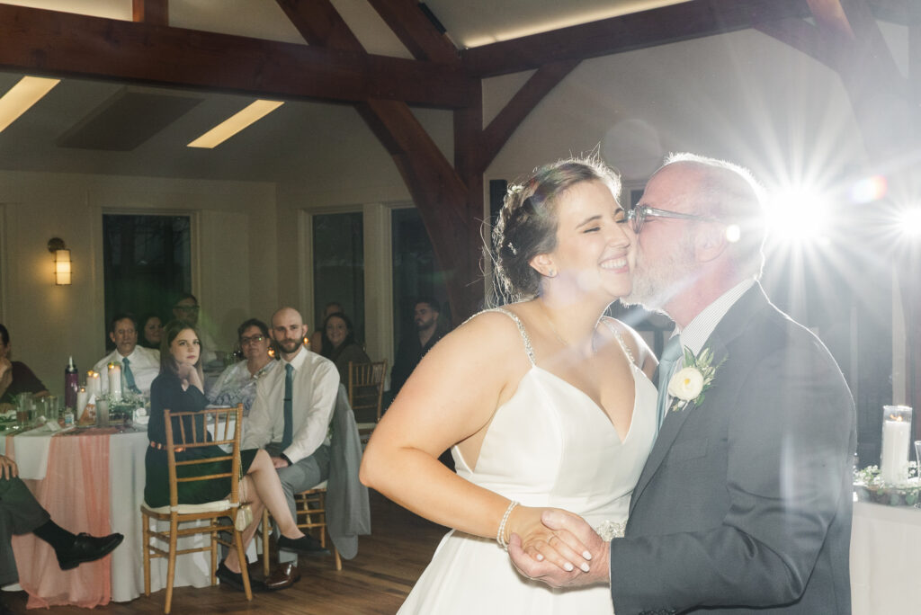 father of the bride kissing his daughter at the end of their dance at Weaver House wedding venue