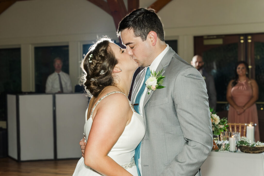 close up of bride and groom kissing at the end of their first dance at Weaver House wedding venue