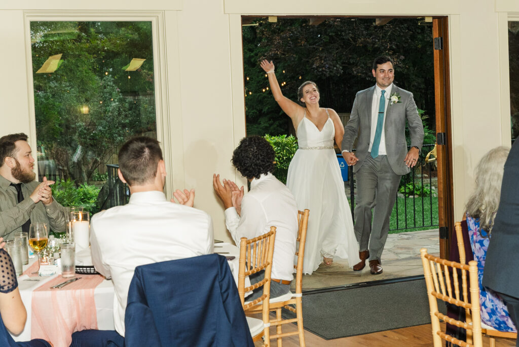 bride and groom walking into their reception at Weaver House wedding venue