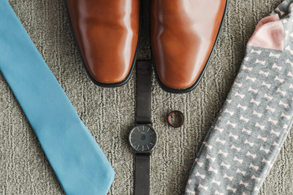 grooms details - shoes, watch, fancy socks, and blue tie