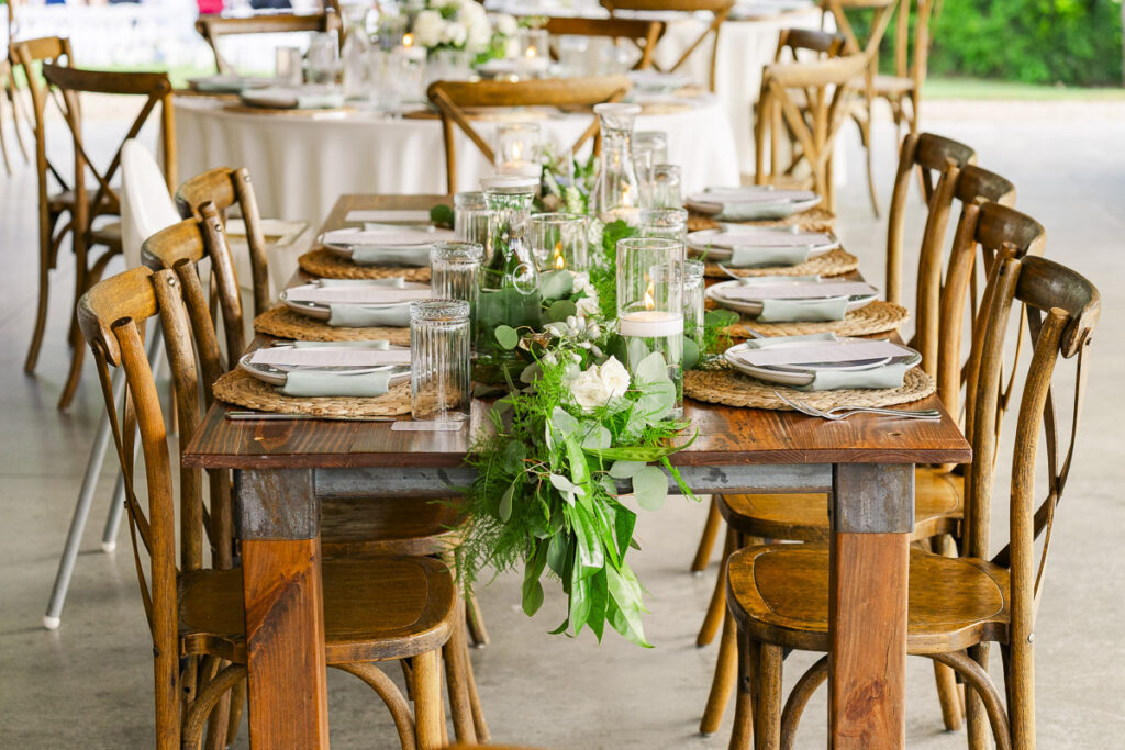 entire set up of reception table decor. candles and greenery down the middle