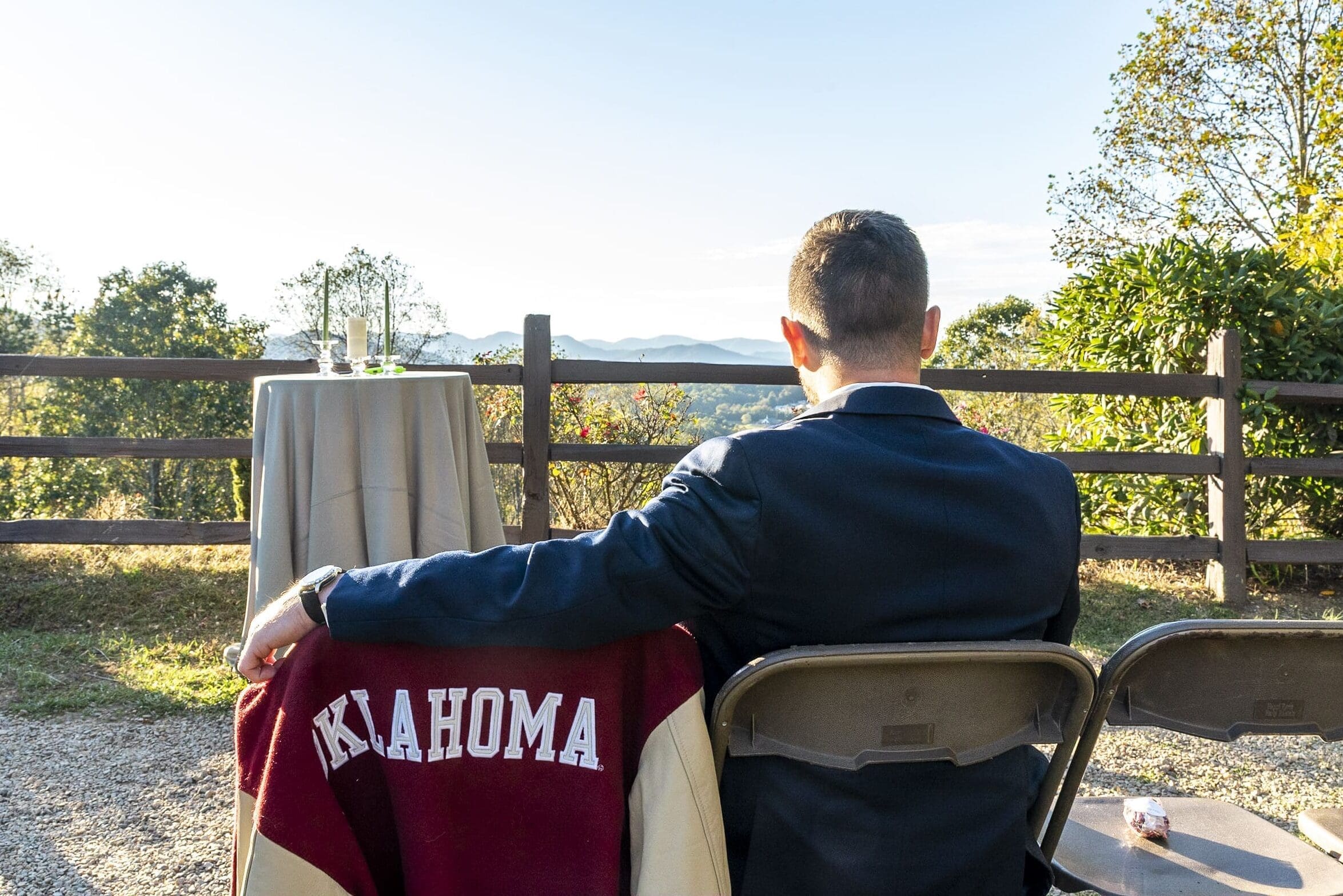 Groom sitting in the seat next to his Father's collage letter jacket at crest center